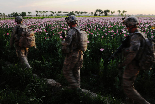 In this photo provided by ISAF Regional Command - South, during Operation Spartan Strike, 2nd Platoon, Company C, 2nd Battalion, 502nd Infantry Regiment, 101st Airborne Division (Air Assault) and service members of the Afghan National Army, Thursday, April 21, 2011, cleared houses and questioned residents about Taliban activities and locations of weapons caches in Zharay District, Afghanistan.
