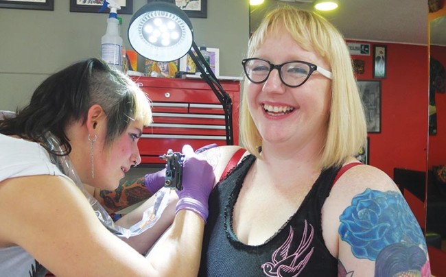 Writer Sarah Genner gets a tattoo in a Bogotá tattoo establishment.