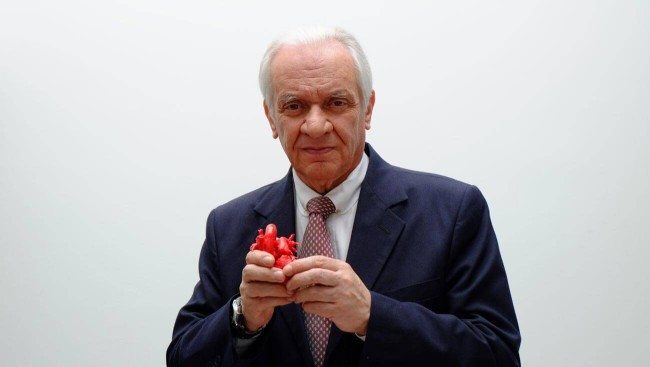 Dr. Jorge Reynolds holds a model of a human heart