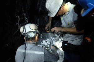 Miners inspect rocks searching for emeralds