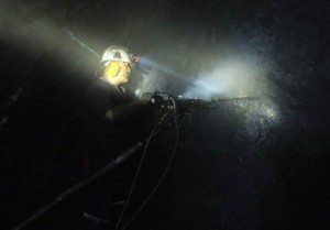 A miner drills into the rock wall searching for emeralds