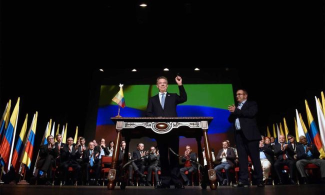 Santos and Timochenko celebrate the signing of a final peace accord in Bogotá.