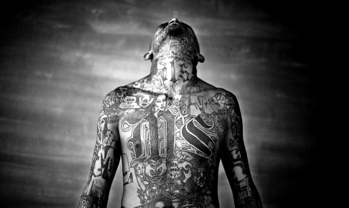 A member of the Mara Salvatrucha gang displays his tattoos inside the Chelatenango prison in El Salvador. Photo: Moisen Saman/Sony World Photography Award.