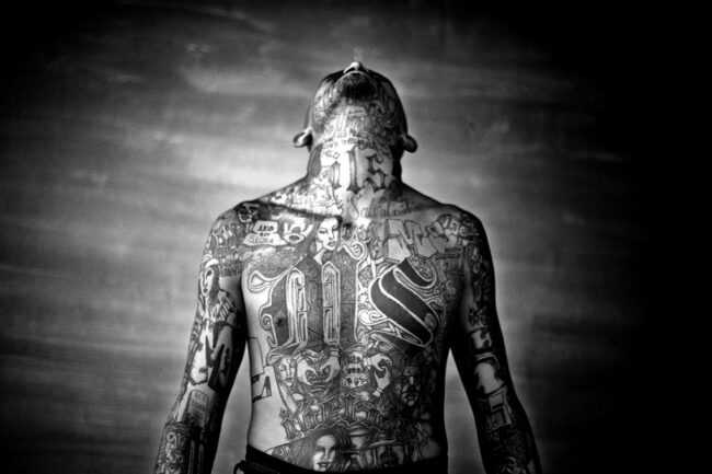 A member of the Mara Salvatrucha gang displays his tattoos inside the Chelatenango prison in El Salvador. Photo: Moisen Saman/Sony World Photography Award.